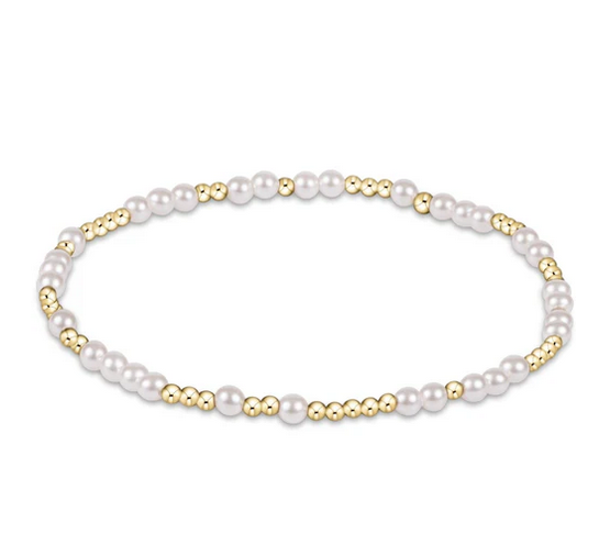 A bracelet made of alternating small gold beads and white pearls.