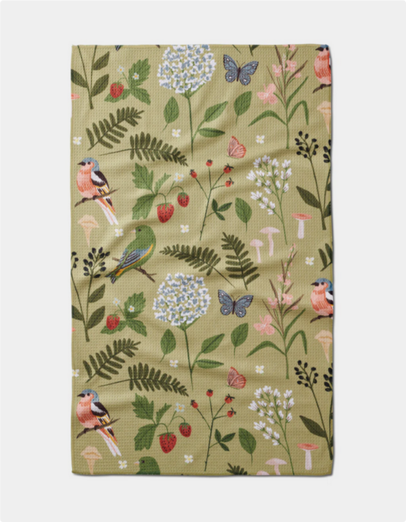 A green tea towel with a pattern of birds, butterflies, strawberries, and flowers.