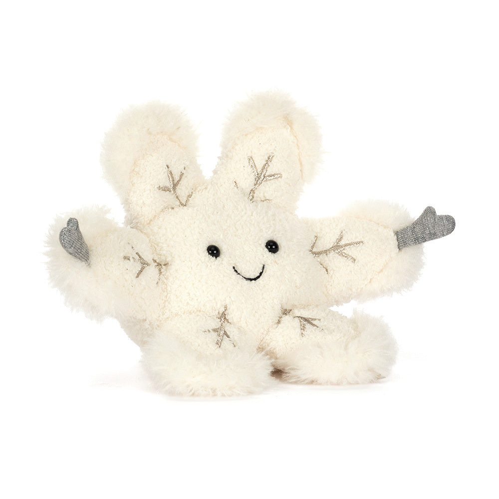 A soft, cream-colored snowflake plush toy with a smiling face and gray accents.