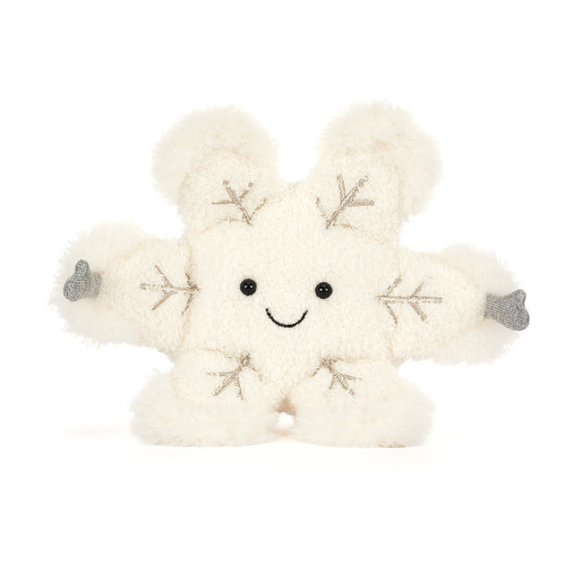 A soft, white snowflake plush toy with a smiling face and embroidered details.