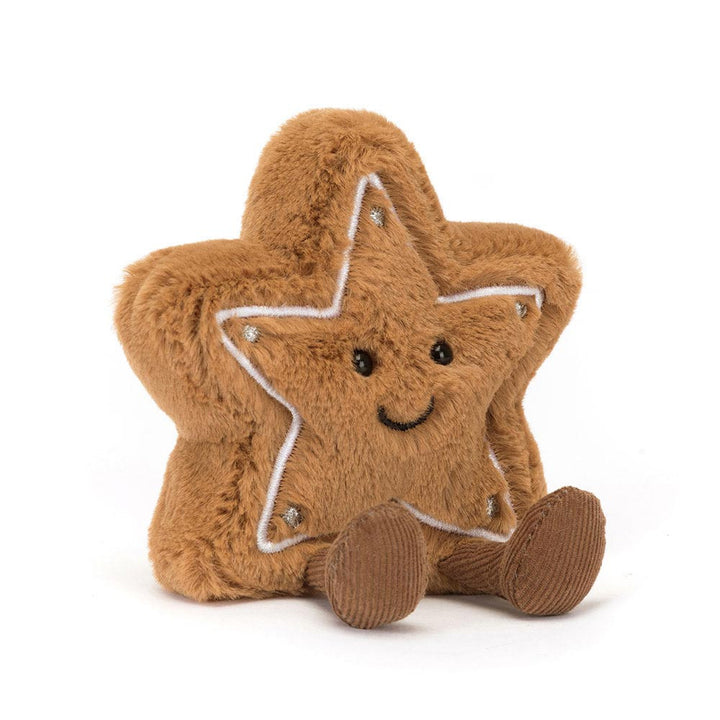 A plush brown star cookie with a white icing outline, a smiling face, and small corduroy feet.