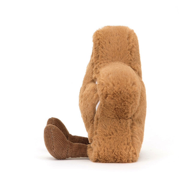 A brown plush toy with corduroy legs sits facing away, revealing its furry back.