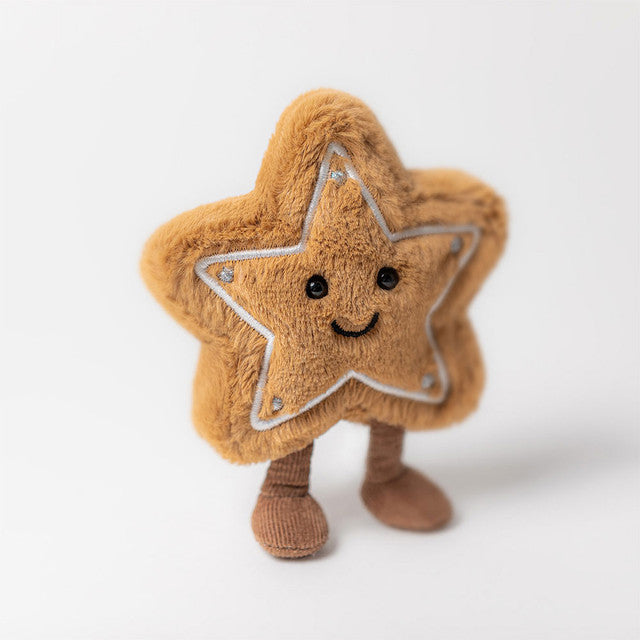 A plush star-shaped cookie with a smiling face and small brown legs.