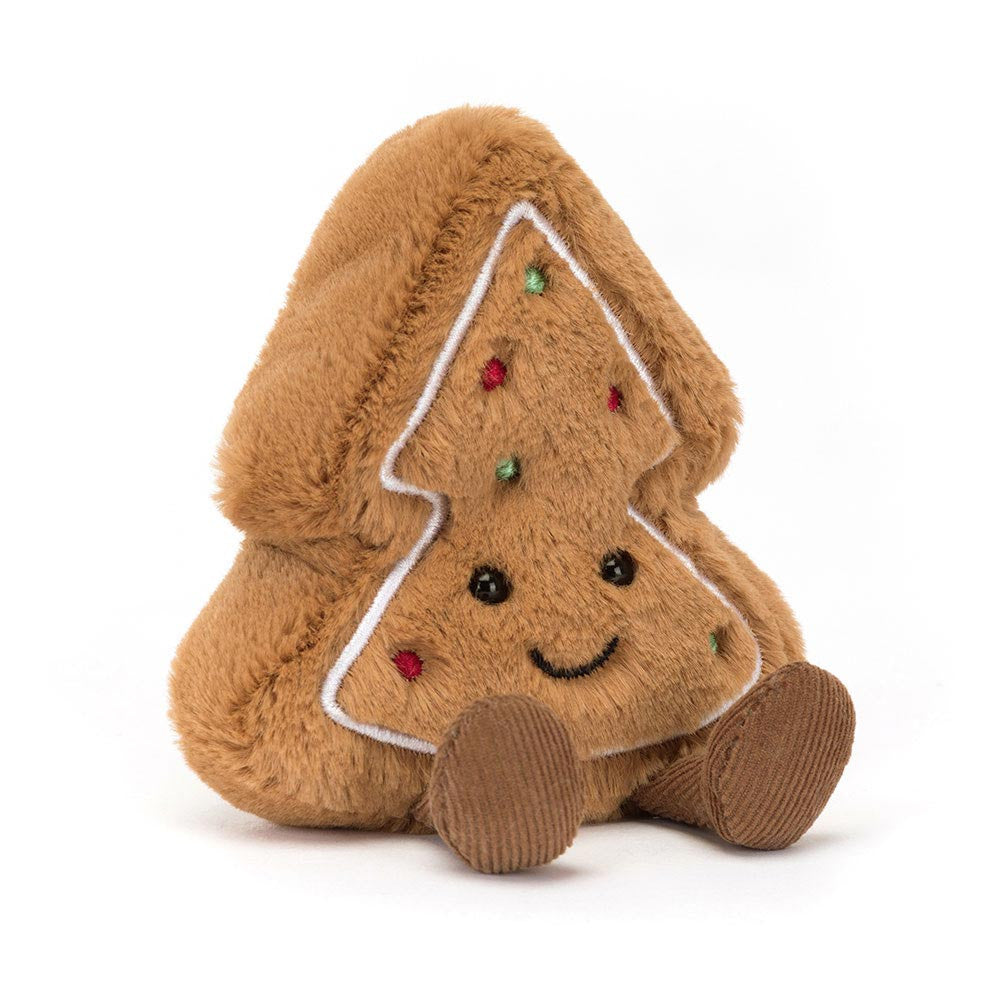 A plush gingerbread tree cookie with a smiling face and colorful sprinkles.