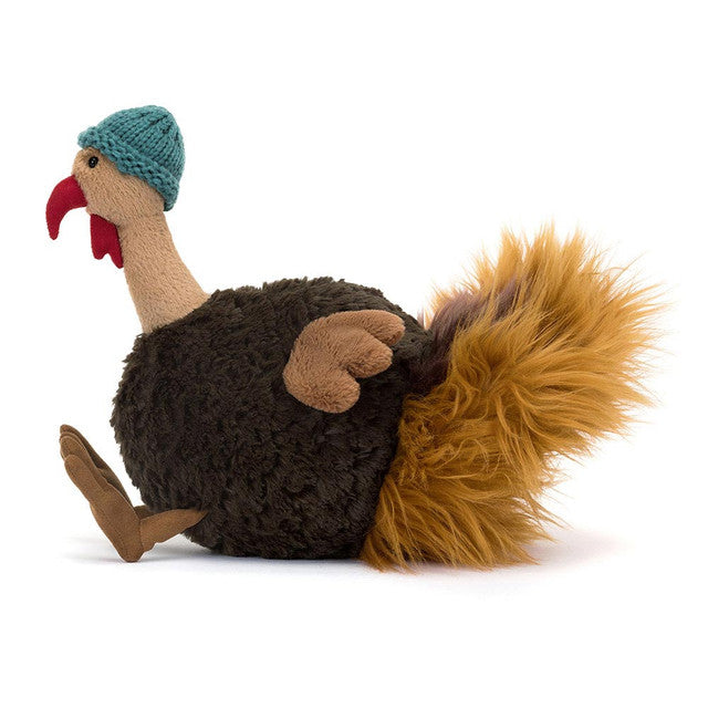 Theo Turkey plush toy wearing a teal knitted hat.