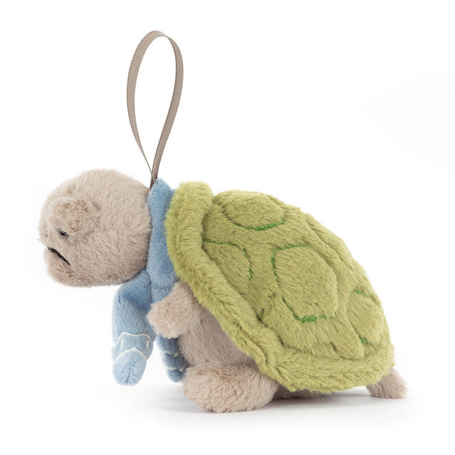 A plush Timmy Turtle ornament with a green shell and blue scarf.
