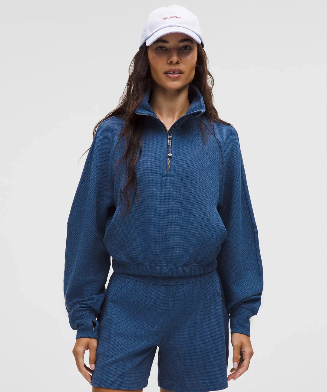 Blue waffle knit cropped half-zip sweatshirt with a funnel neck.